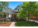 Charming home with a well-manicured lawn, mature tree, and inviting front porch at 1612 S Logan St, Denver, CO 80210