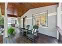 Inviting front porch with rocking chairs, wood ceiling, and decorative fern accents at 1612 S Logan St, Denver, CO 80210