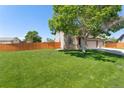 Beautiful home featuring a spacious lawn and a charming exterior with a three car garage at 12814 Forest Cir, Thornton, CO 80241
