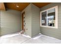 Inviting front entry with a modern door and side window at 10081 Truckee St, Commerce City, CO 80022