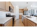 Well-equipped kitchen with stainless appliances, ample counter space, and natural wood cabinetry at 18953 E 97Th Ave, Commerce City, CO 80022