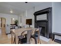 Cozy dining room featuring a fireplace, hardwood floors, and modern decor at 1825 W 32Nd Ave, Denver, CO 80211