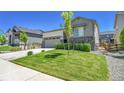 Lovely home with green lawn and landscaping; a view of the front and side of the house at 4040 Eaton Park St, Aurora, CO 80019