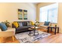 Cozy living room featuring hardwood floors, comfortable seating, and a neutral color palette at 6424 Silver Mesa Dr # C, Highlands Ranch, CO 80130