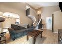 Inviting living room with open staircase, modern lighting, hardwood floors, and a comfortable sofa at 11376 Forest Dr, Thornton, CO 80233