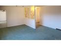 Bright living room featuring decorative wall elements and carpeted flooring at 5922 S Otis Ct, Littleton, CO 80123