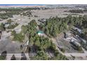 Wide aerial view of a home nestled among trees in a quiet, expansive neighborhood at 34480 Pine Ridge Cir, Elizabeth, CO 80107