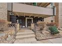 Elegant entrance with stone accents, lush landscaping, and prominent building number creates a welcoming facade at 700 N Washington St, Denver, CO 80203