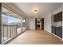 Bright living room features sliding glass doors to balcony, opening to the kitchen at 700 N Washington St, Denver, CO 80203