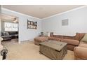 Spacious living room with a large sectional sofa, neutral carpeting, and adjacent dining area at 1200 Butterfield Ln, Castle Rock, CO 80104