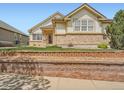 Lovely home with brick accents, enhanced curb appeal, and a well-kept lawn at 7922 S Algonquian Way, Aurora, CO 80016