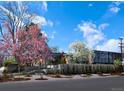 A modern residence showcases spring blossoms, manicured landscaping, and architectural design under a bright sky at 101 S Humboldt St, Denver, CO 80209
