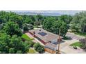 Aerial view showcases the home, large lot, solar panels, and mountain views at 11542 W 29Th Pl, Lakewood, CO 80215