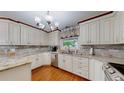 Well-lit kitchen with granite countertops, stainless steel appliances and hardwood floors at 11542 W 29Th Pl, Lakewood, CO 80215
