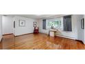 Spacious living room featuring hardwood floors and a large window at 11542 W 29Th Pl, Lakewood, CO 80215