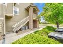 Side exterior featuring staircase with stone accents and green bushes at 3261 S Waco Ct # C, Aurora, CO 80013