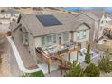 Spacious back deck features patio furniture and a solar panel system on the roof at 7262 Serena Dr, Castle Pines, CO 80108