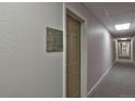 Long hallway features neutral gray carpet, textured walls, and recessed lighting near apartment 13 at 1629 N Clarkson St # 13, Denver, CO 80218