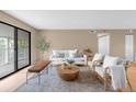 Bright living room with neutral walls, large windows, and comfortable seating area at 921 S Walden Street # 205, Aurora, CO 80017