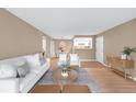 Open floor plan showcases a seamlessly integrated living and dining area with modern decor and wood flooring at 921 S Walden Street # 205, Aurora, CO 80017
