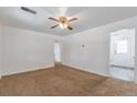 Spacious living room with carpet flooring and a ceiling fan, bathed in natural light at 6900 E 66Th Ave, Commerce City, CO 80022