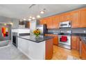 Spacious kitchen with granite countertops, stainless steel appliances, and center island with breakfast bar at 4100 Albion St # 307, Denver, CO 80216