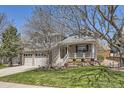 Charming two-story home features a welcoming front porch and beautifully landscaped front yard at 9916 Spring Hill Ln, Highlands Ranch, CO 80129