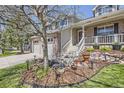 Beautifully landscaped front yard with decorative lighting and elegant stone and mulch landscaping elements at 9916 Spring Hill Ln, Highlands Ranch, CO 80129