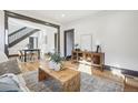 Open living space with hardwood floors, and a view of the dining area at 1155 Garfield St, Denver, CO 80206