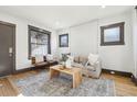 Living area with hardwood floors, white walls, and a cozy sitting area at 1155 Garfield St, Denver, CO 80206