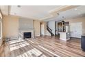 Bright open-concept living room, hardwood floors, fireplace, and seamless flow to the kitchen at 4625 Walden Ct, Denver, CO 80249