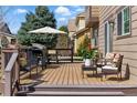 Outdoor deck features a grill, seating, umbrella, and views of the surrounding neighborhood and trees at 18130 Bolero Dr, Parker, CO 80134