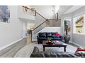 Open living room features a staircase, hardwood floors and an abundance of natural light at 18130 Bolero Dr, Parker, CO 80134