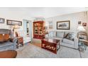 Inviting living room featuring a decorative curio cabinet and a comfortable seating arrangement at 518 Cherry St, Hudson, CO 80642