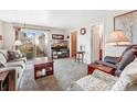 Relaxing living room with sliding glass doors, plush seating, and a large television at 518 Cherry St, Hudson, CO 80642