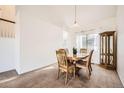 Dining room with a round table set and decorative wood display cabinet at 2228 Gold Dust Trl, Highlands Ranch, CO 80129