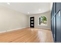 Bright and airy living room with hardwood floors, modern lighting, and an arched window at 1045 Locust St, Denver, CO 80220