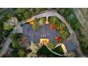 An aerial view of an estate showcasing the roofline, driveway, landscaping, and surrounding trees at 1 Greenridge Rd, Greenwood Village, CO 80111