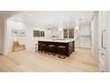 Bright, modern kitchen featuring a large center island with seating and stainless steel appliances at 1 Greenridge Rd, Greenwood Village, CO 80111
