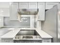 Modern kitchen with stainless steel range and white quartz countertops at 5995 W Hampden Ave # 5I, Denver, CO 80227