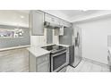 Modern kitchen with stainless steel appliances and gray cabinets at 5995 W Hampden Ave # 5I, Denver, CO 80227