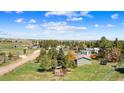 Spacious green lot with charming house, outbuildings, and a fenced yard near treed neighborhood at 1151 Buttercup Rd, Elizabeth, CO 80107