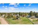 Expansive green lot with a charming home and outbuildings, set in a rural, treed neighborhood at 1151 Buttercup Rd, Elizabeth, CO 80107