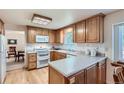 Bright kitchen features wooden cabinets, white appliances, and lots of counter space at 2093 S Holland St, Lakewood, CO 80227