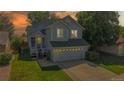 Two-story home with a well-manicured lawn and an attached two-car garage at sunset at 3755 Shefield Dr, Broomfield, CO 80020