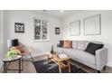 Inviting living area featuring a stylish sofa, decor, and a large window at 855 Newark St, Aurora, CO 80010