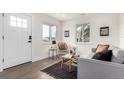 Bright living room with contemporary decor, wood floors, and lots of natural light at 855 Newark St, Aurora, CO 80010