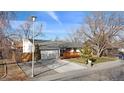 Newly remodeled home with a well-maintained lawn and a welcoming front porch at 6749 Ingalls St, Arvada, CO 80003