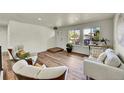 Bright and airy living room with hardwood floors and comfortable seating at 6749 Ingalls St, Arvada, CO 80003