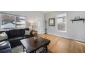 Inviting living room with a comfortable couch, large windows, and hardwood flooring at 3629 Kalamath St, Denver, CO 80211